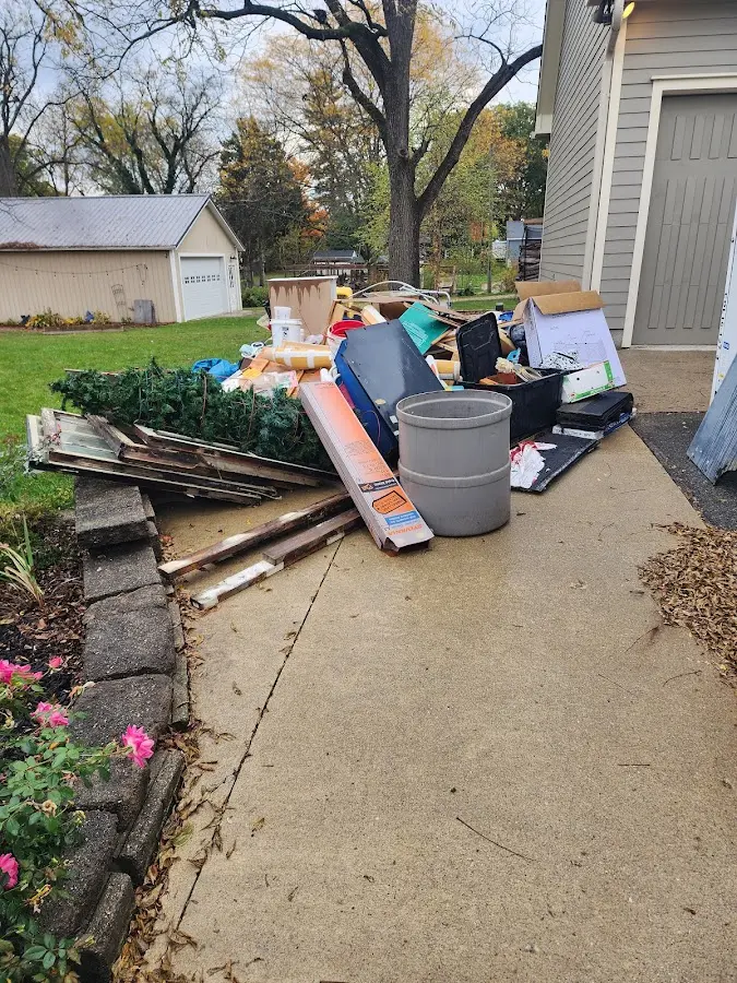 Dumpster being loaded with debris for Commercial Dumpster Rental in Jefferson City